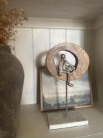 Front view of silver figure on home decor accessory
