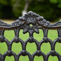 Close up of decorative motif on backrest of garden bench  Close up of decorative motif on backrest of garden bench