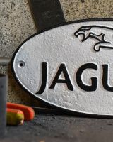 Close up of "Jaguar" Cast Iron Automobilia Reproduction Sign Finish Close up of "Jaguar" Cast Iron Automobilia Reproduction Sign Finish