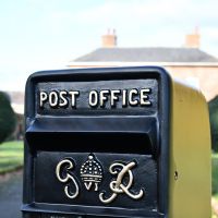 Close-up of the Gold Wording on the King George Rex Black Period Post Box Close-up of the Gold Wording on the King George Rex Black Period Post Box