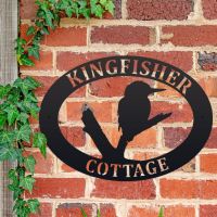 Kingfisher Iron Oval House Sign on a Brick Wall