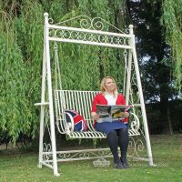 Lady sitting on garden swing seat