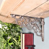 Cherub Iron Shelf Bracket Holding up a Wooden Shelf