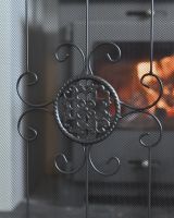 Close up of metal detailing on black fire guard
