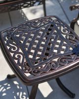 Close up of scrollwork detailing and lattice patternwork on the side table.