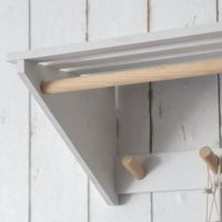 White Slatted Laundry Shelf with Hooks Close Up
