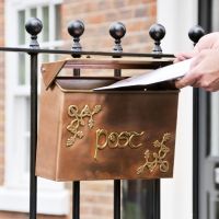 Antique Copper and Bass Celtic Design Post Box in Situ on a Fence Antique Copper and Bass Celtic Design Post Box in Situ on a Fence