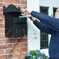 Post & parcel box on wall in use