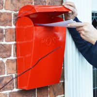 Red post box with lid lifted Red post box with lid lifted