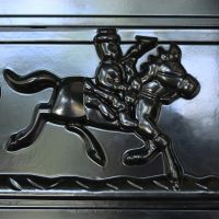Detailed image of man riding horse on front of letter box door