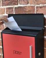 Posting a letter in contemporary box Posting a letter in contemporary box