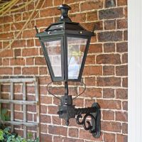 Black Dorchester garden lantern on brick wall Black Dorchester garden lantern on brick wall