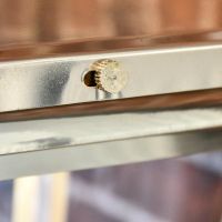 Close up of matching polished brass screw 