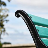 Close up of black cast iron bench frame 
