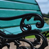 Close up of filigree detailing on cast iron arm rest 
