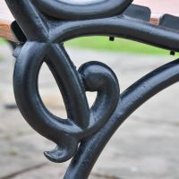 Close up of cast iron arched arm rest 