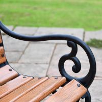 Close up of cast iron scroll arm rest 