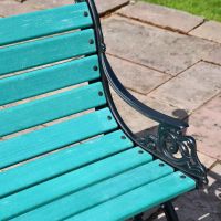 Close up of "green" slats and cast iron arm rest  Close up of "green" slats and cast iron arm rest