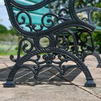Close up of black scroll detailing on bench legs