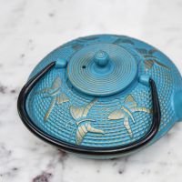 Light Blue "Butterfly" Cast Iron Teapot with Handle Down in Situ Light Blue "Butterfly" Cast Iron Teapot with Handle Down in Situ