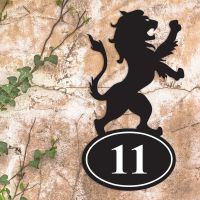Lion Iron House Number Sign on a Garden Wall