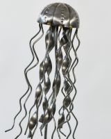 Close up of intricate jellyfish detail on recycled metal art sculpture