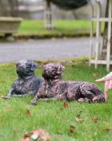 "Barney" the Labrador Cast Iron Garden Sculpture - Copper lying next to verdigris version