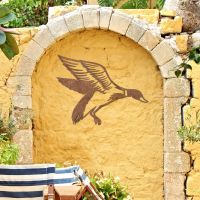 "Mallard" Duck Wall Art on a Yellow Wall in the Garden