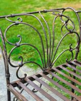 Close up of rustic finish on outdoor two seater bench