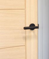 Matte Black Textured Unsprung Lever Door Handle on Rose in Situ Matte Black Textured Unsprung Lever Door Handle on Rose in Situ
