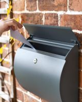 Close-Up of Letter Aperture in Use on Wall-Mounted Post Box