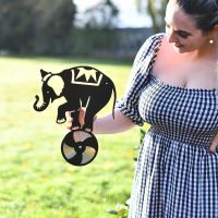 Metal and CD Elephant On Ball Being Held