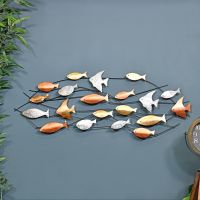 Metallic Swimming Fish Wall Art in Situ on a Blue Wall