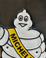 Close up of hand painted face detail on cast iron wall art