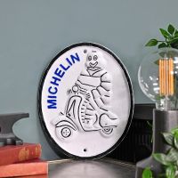 "Michelin Man" Scooter Cast Automobilia Reproduction Sign in Situ Next to a Blue Wall "Michelin Man" Scooter Cast Automobilia Reproduction Sign in Situ Next to a Blue Wall