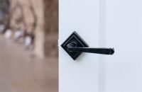 Midnight Black Lever Door Handle on Diamond Rose on Door