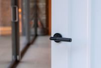 Midnight Black Textured Lever Door Handle on Rose in Situ