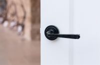 Midnight Black Unsprung Lever Door Handle on Art Deco Rose on Door Midnight Black Unsprung Lever Door Handle on Art Deco Rose on Door
