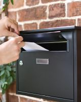 Scale Shot of Posting Letters on Modern Black Steel Front Opening Wall Mounted Post Box with Lock