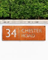 Rustic House Number Sign on a Garden Wall