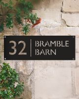 Modern Rectangular Steel House Number Sign on a Rustic Sandstone Wall  Modern Rectangular Steel House Number Sign on a Rustic Sandstone Wall