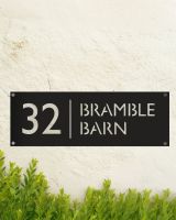 Modern Rectangular Steel House Number Sign in Situ on a Painted Wall 