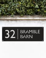 Modern Rectangular Steel House Number Sign in Situ on a Garden Wall 