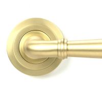 Close-Up of Modern Satin Brass "Neville" Art Deco Door Handle on Rose Set - 53mm Close-Up of Modern Satin Brass "Neville" Art Deco Door Handle on Rose Set - 53mm