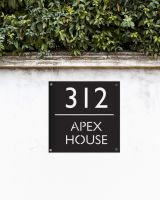 Modern Square Steel House Number Sign on a White Garden Wall  Modern Square Steel House Number Sign on a White Garden Wall