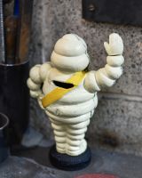 Close up of moneybox detail on michelin man statue
