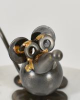 Close up of intricate face detail on recycled metal art sculpture