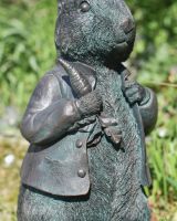 Close up of intricate clothes and carrot detail on garden sculpture