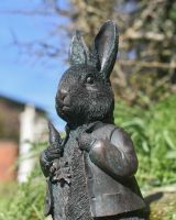 Angled view of intricate face and hair detail on rabbit garden statue