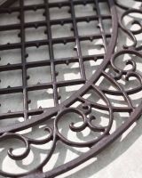 Close-Up of Ornate Pattern on Arched Doormat